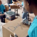 close up of woman marking donation boxes while vol 2022 11 16 14 40 42 utc