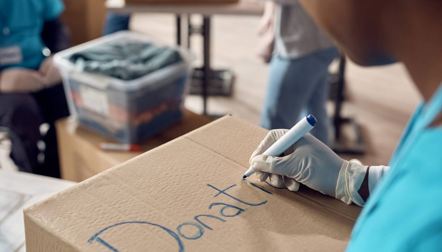 close up of woman marking donation boxes while vol 2022 11 16 14 40 42 utc